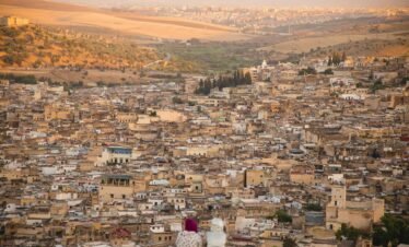 Panoramic view of the ancient city of Fes with its historic rooftops and medina, perfect for those who Explore Fes and Atlas