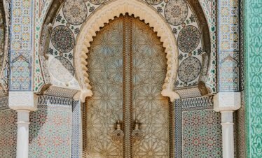 The ornate Royal Palace Gate adorned with traditional Moroccan designs, a highlight when you Explore Fes and Atlas