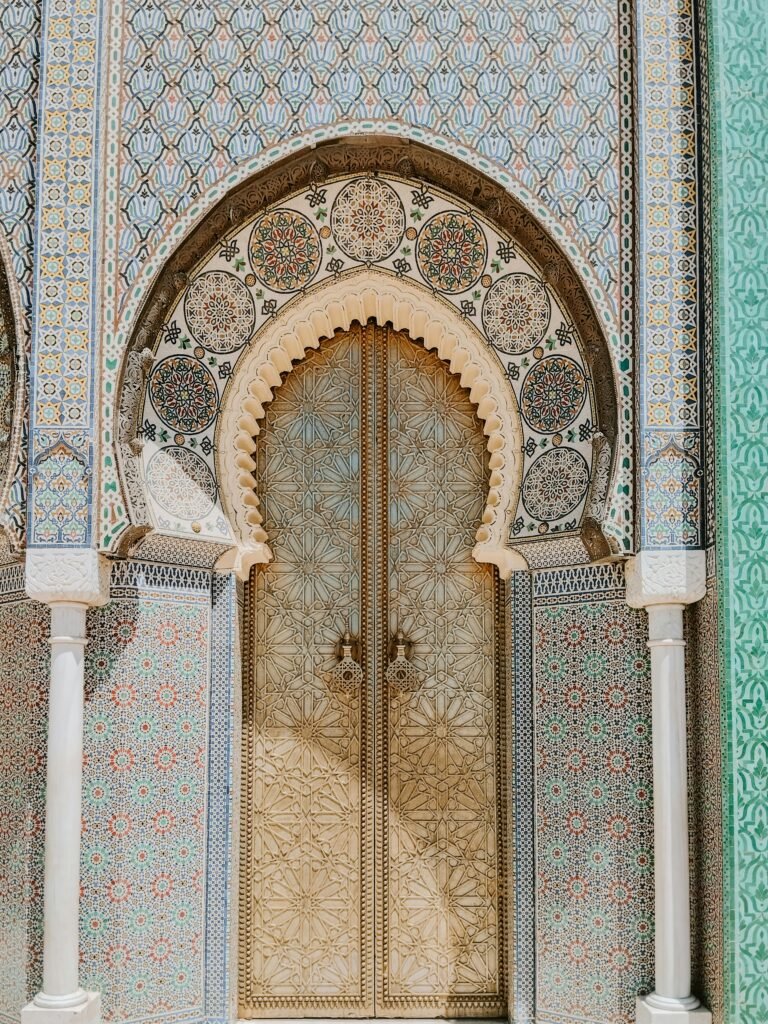 The ornate Royal Palace Gate adorned with traditional Moroccan designs, a highlight when you Explore Fes and Atlas